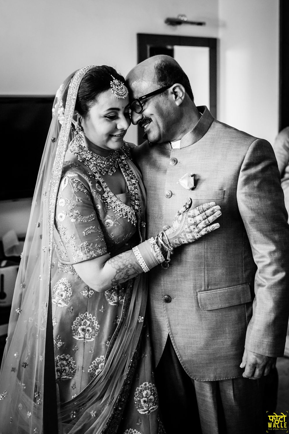 Photo of A monochrome shot of a bride with her father.