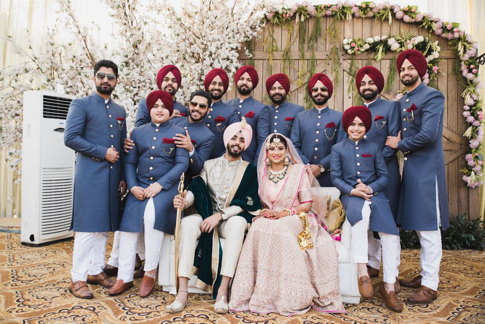 Photo of Sikh couple with coordinated groomsmen