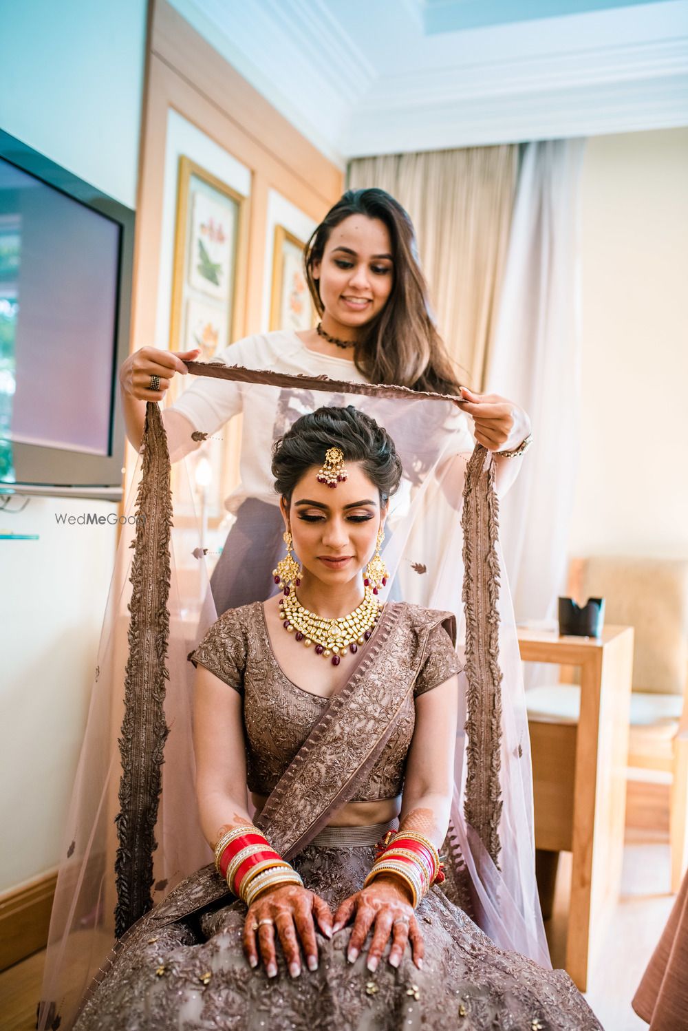 Photo of Sister placing dupatta on head shot