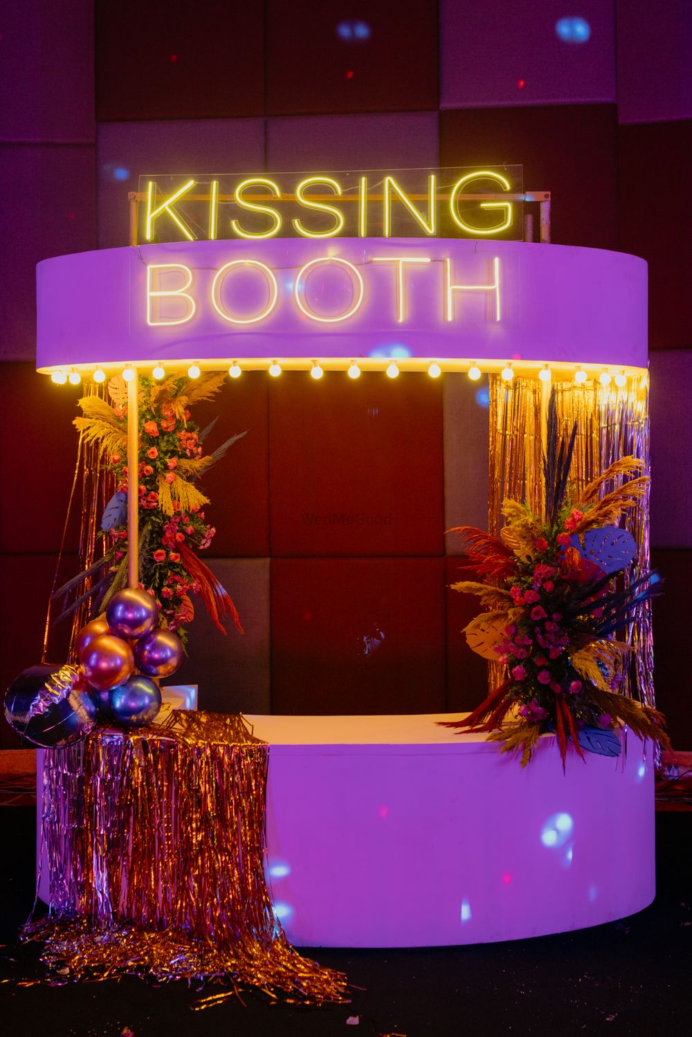 Photo of Fun kissing booth at a wedding in hues of lilac with metallic balloons for decor