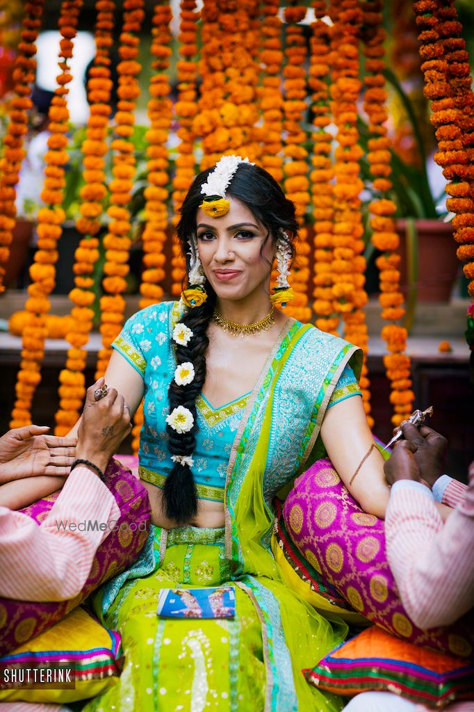 Photo of Unique mehendi hairstyle side braid with flowers