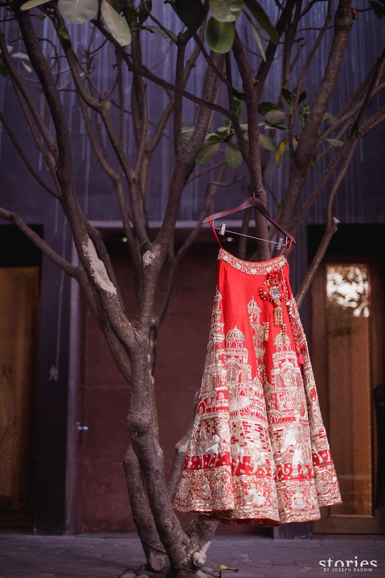 Photo of Bridal lehenga with unique embroidery on hanger