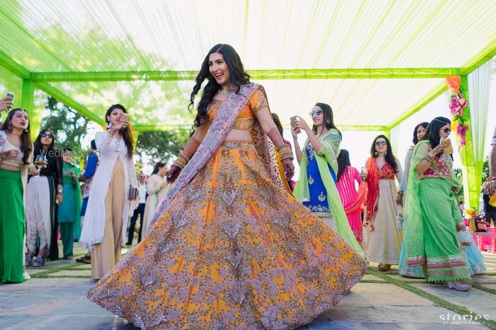 Photo of Yellow and pink mehendi lehenga by Anamika Khanna