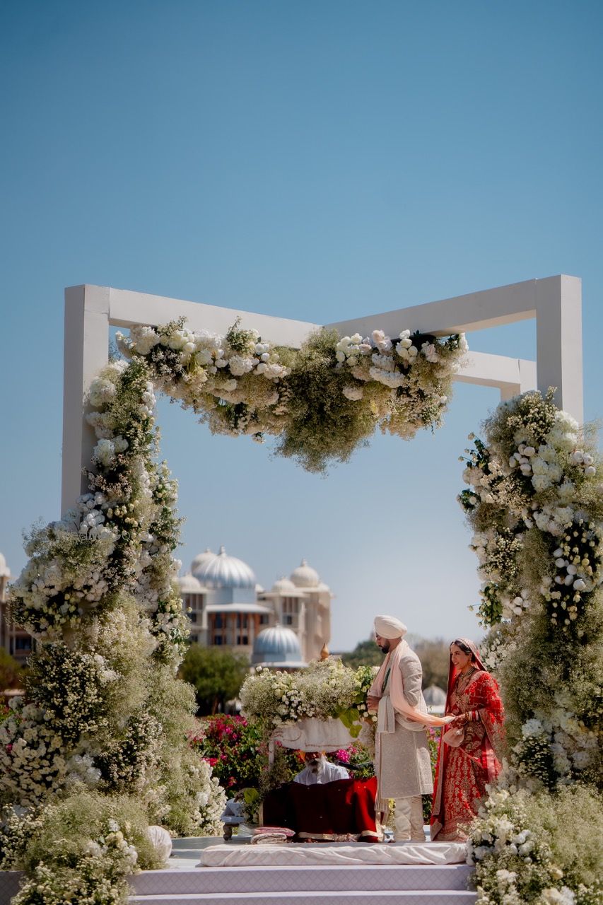 Photo of Unique mandap design with white floral decor for the wedding day
