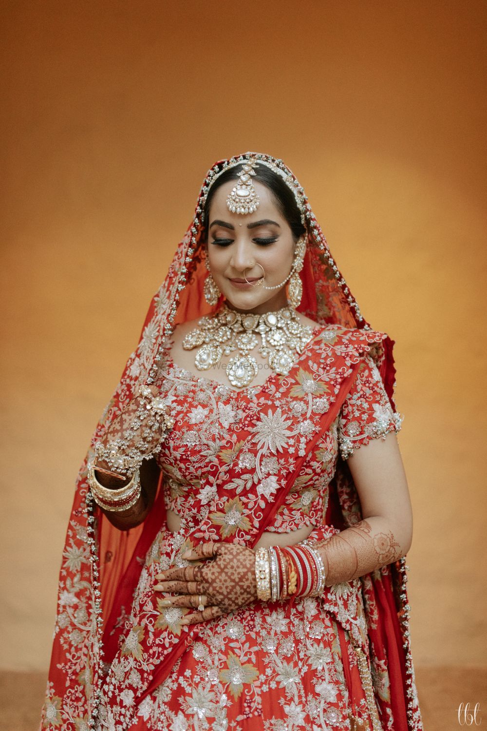 Photo of heavy bridal look in red anamika khanna lehenga and polki jewellery