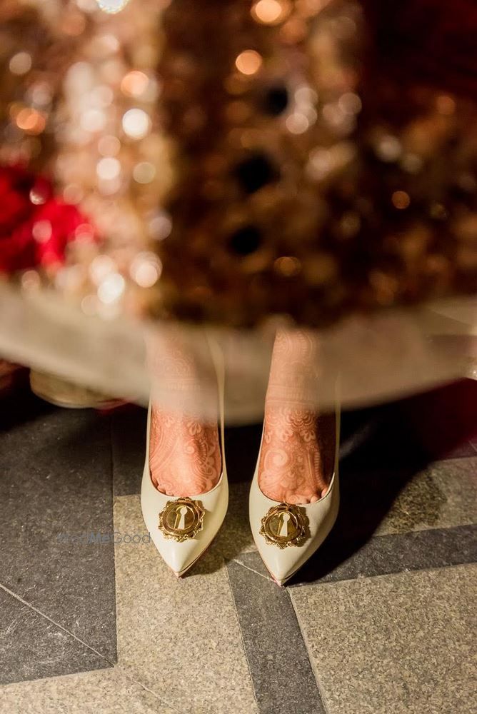 Photo of White pointed tow shoes by Louboutin