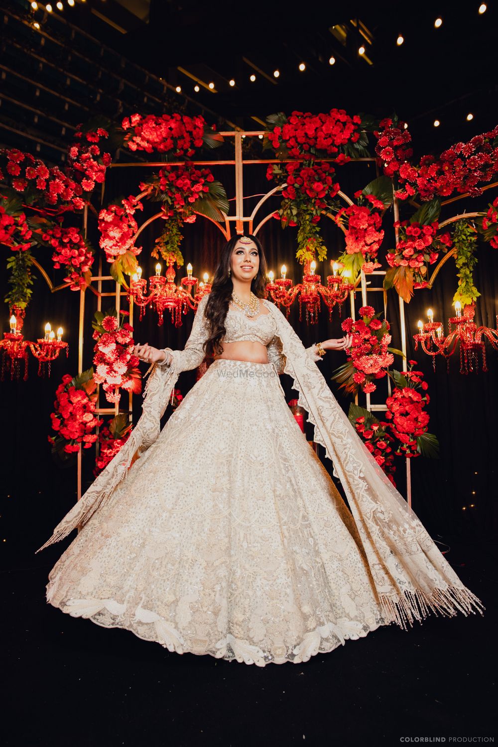 Photo of Bride twirling in her ivory lehenga on her Sangeet.