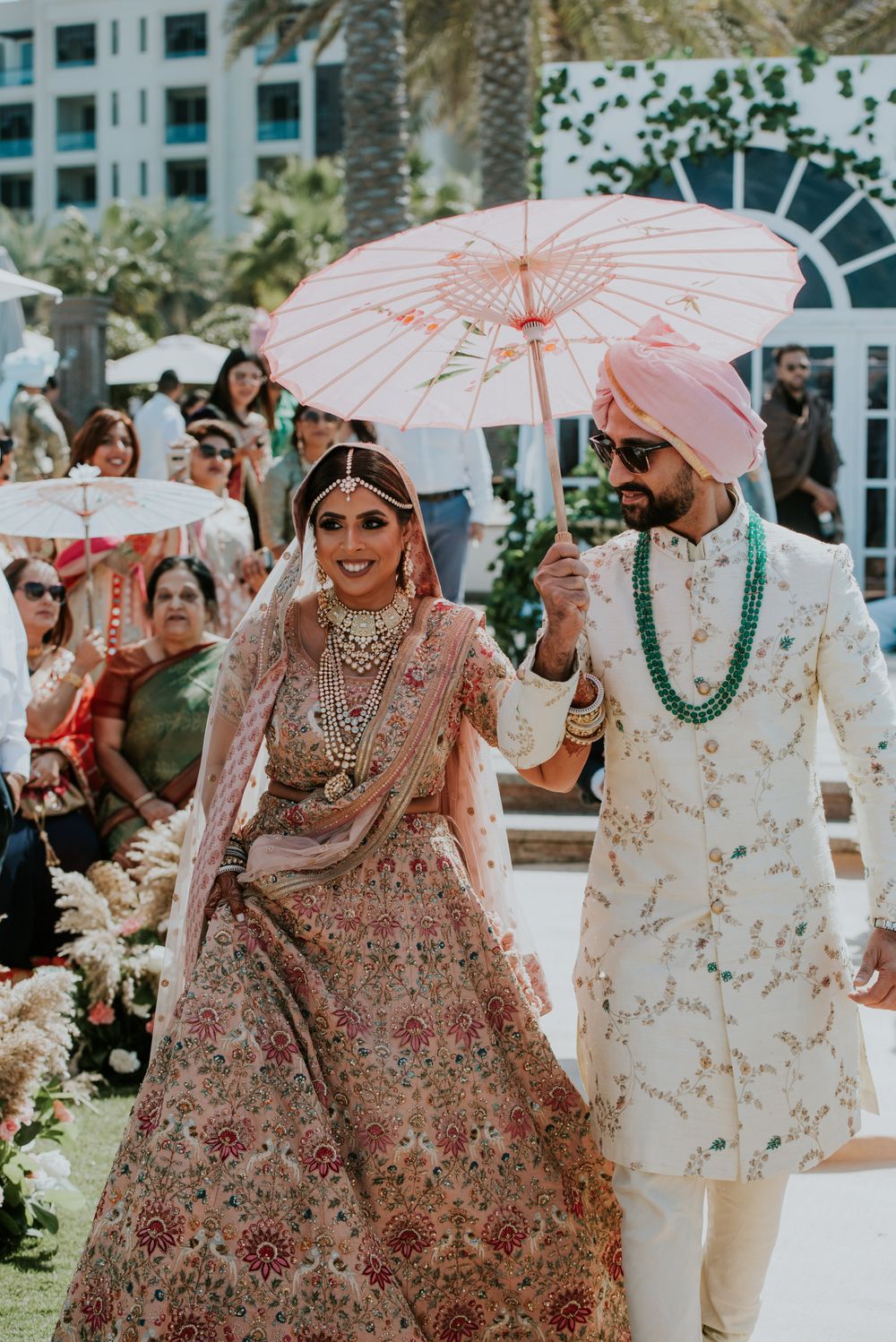 Photo of bridal entry with her brother under an umbrella