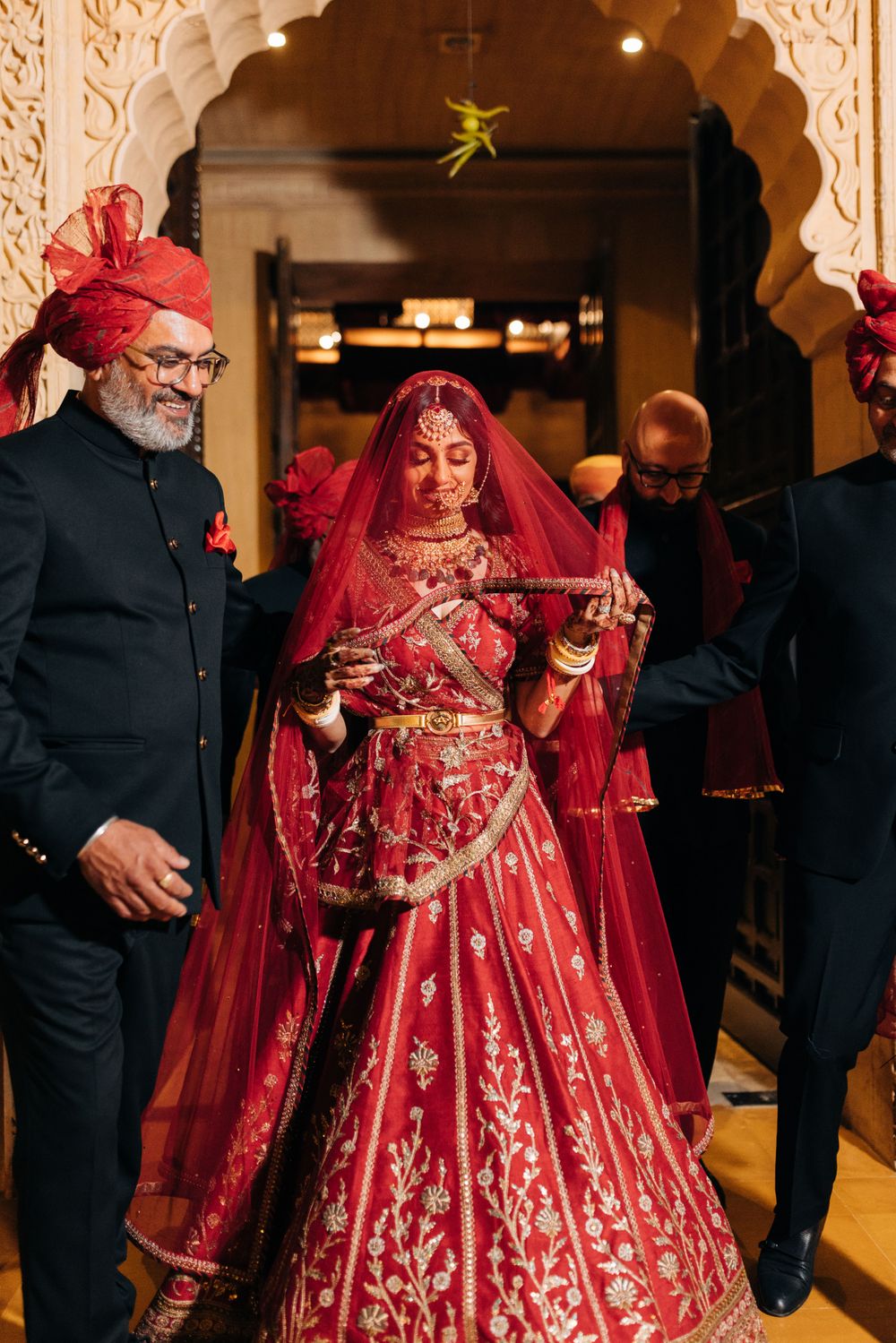 Photo of bride in red lehenga during bridal entry