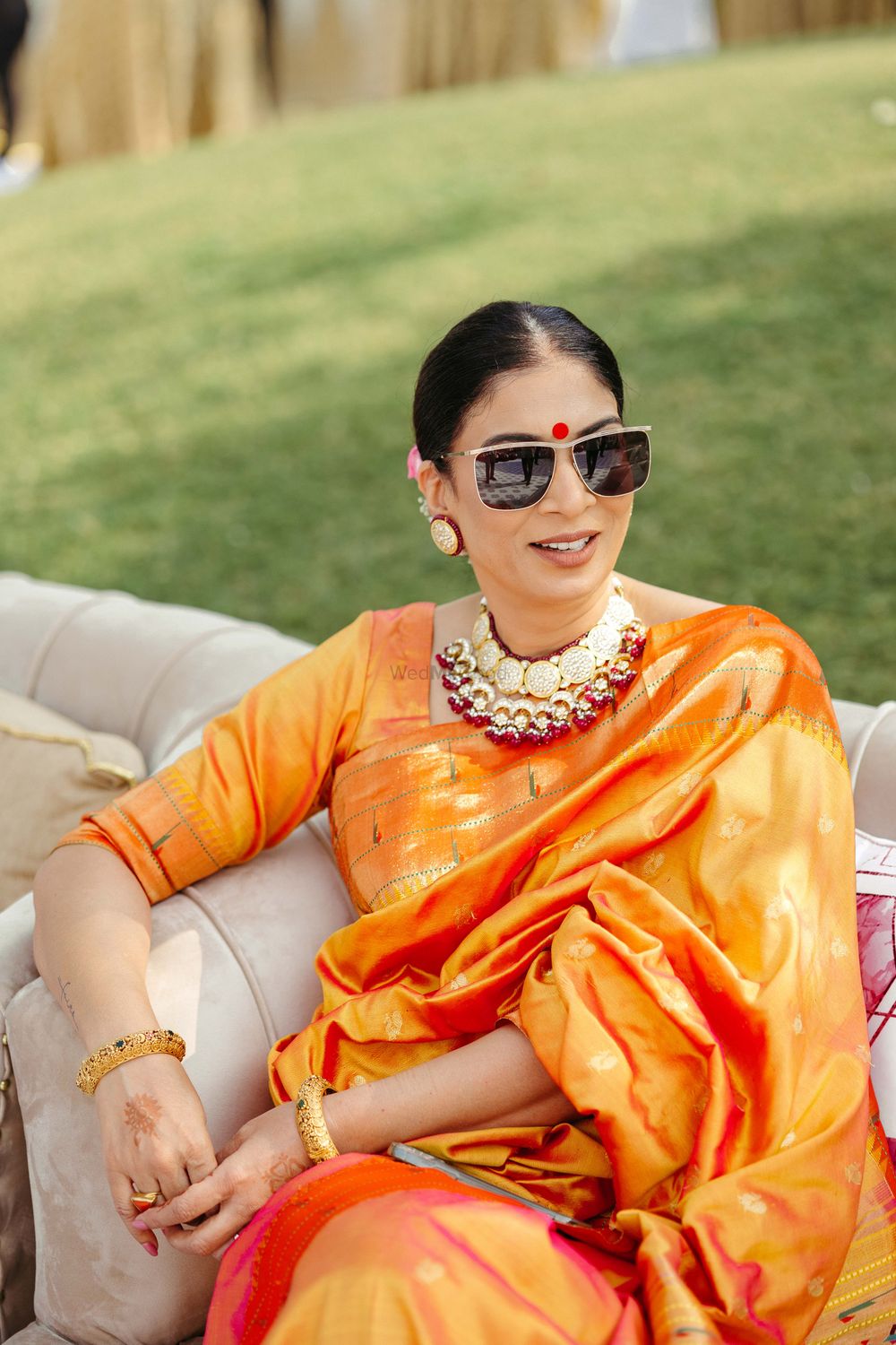 Photo of mother of the bride in an orange saree