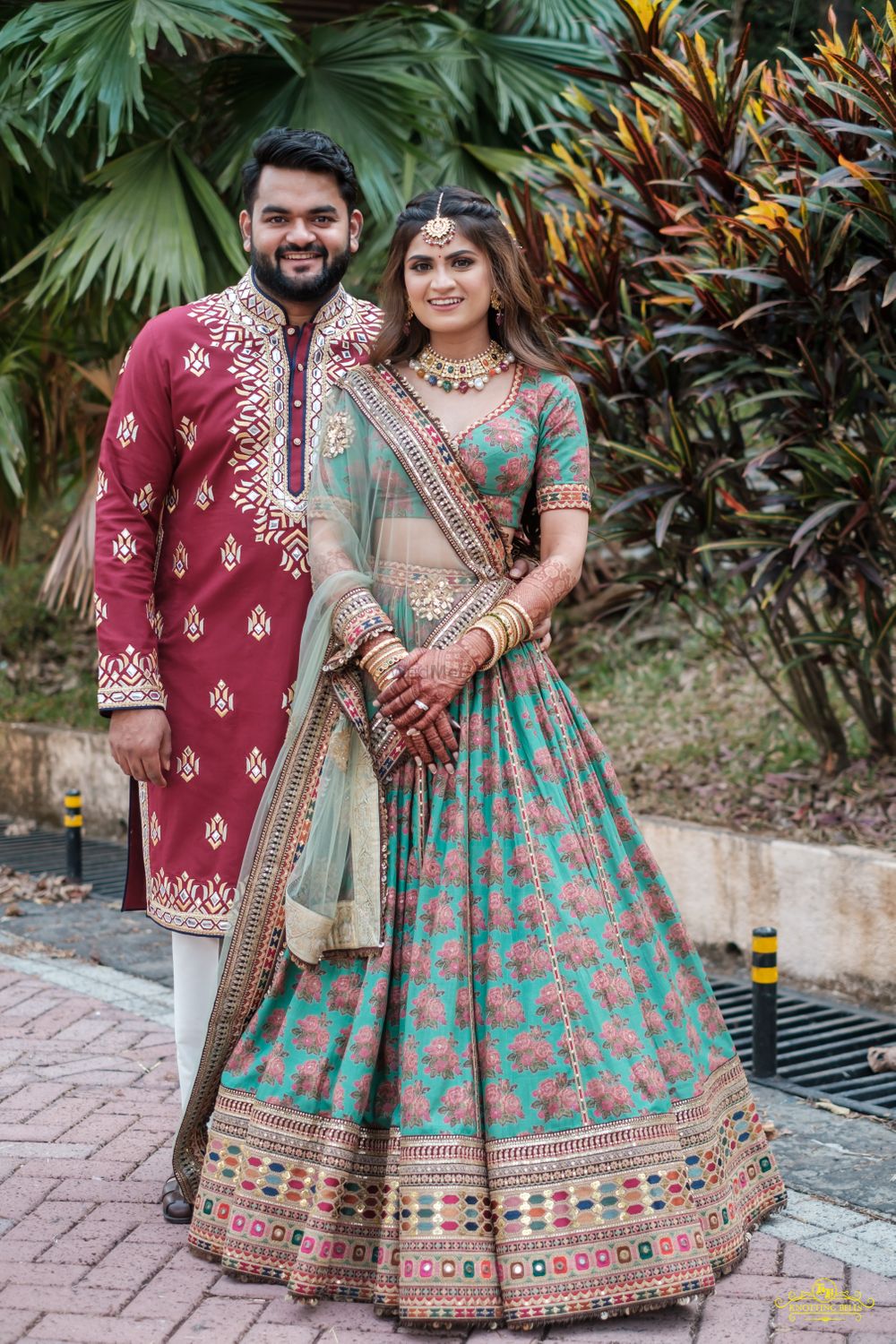 Photo of Bride and groom color-contrasting on their mehendi.
