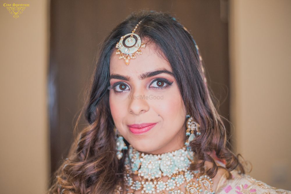 Photo of Contrasting blue pastel jewellery with pink lehenga