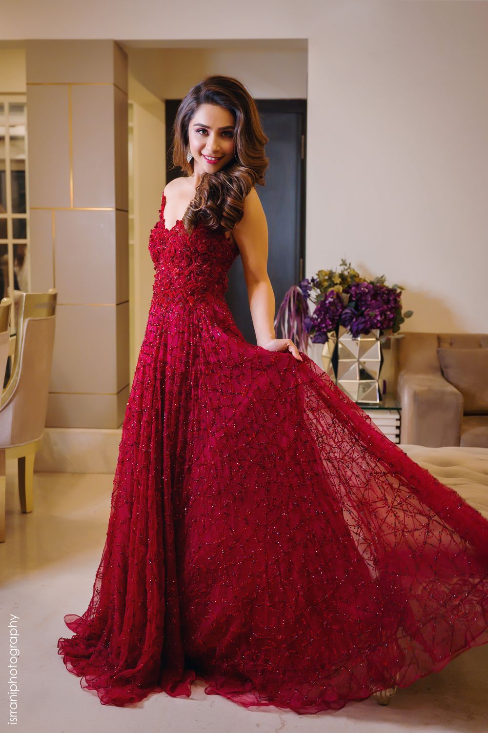 Photo of A gorgeous bridal portrait of the bride in a red gown