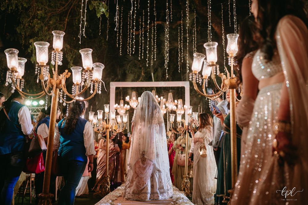 Photo of beautiful bride in white under fairy lights