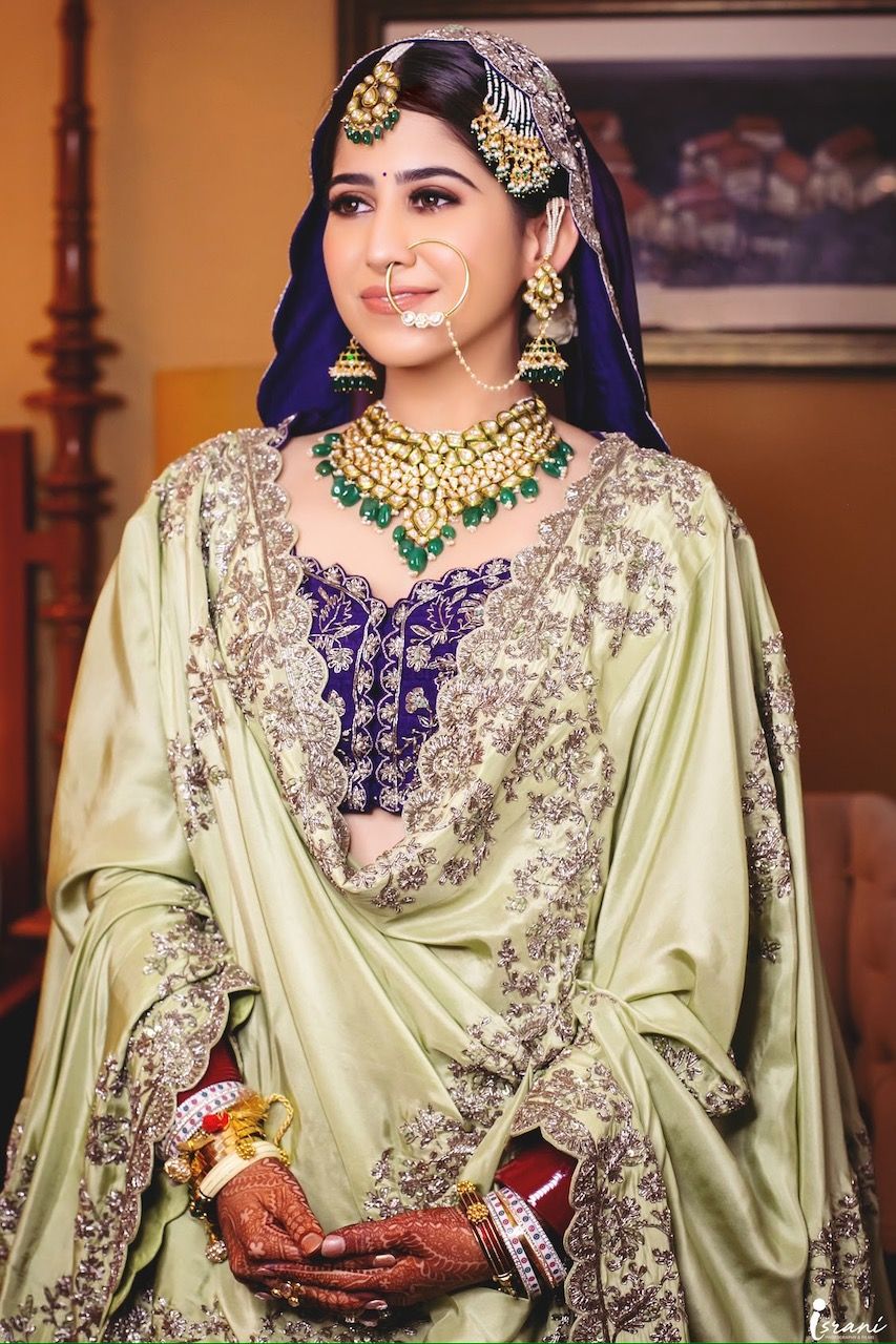 Photo of Sikh bride in deep purple lehenga with mint green scalloped dupatta