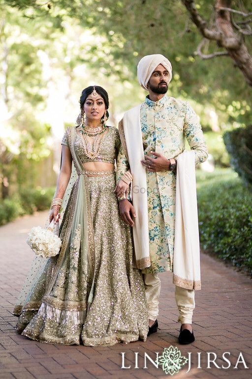 Photo of Coordinated bride and groom in pretty outfits