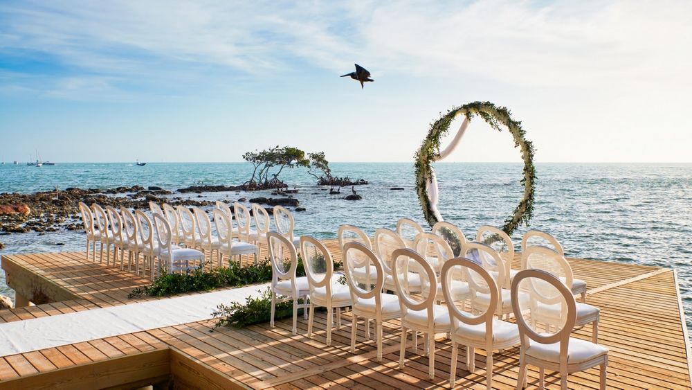 Photo of simple mandap for beachside wedding with chairs
