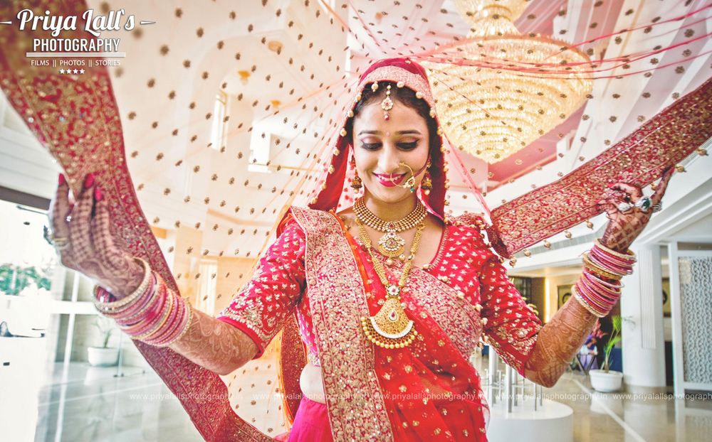 Photo of Bride in Red Lehenga with Layered Necklaces