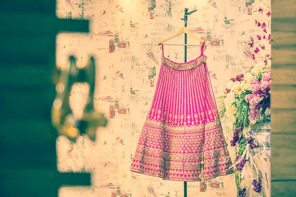 Photo of Bright pink lehenga on hanger with sequin work