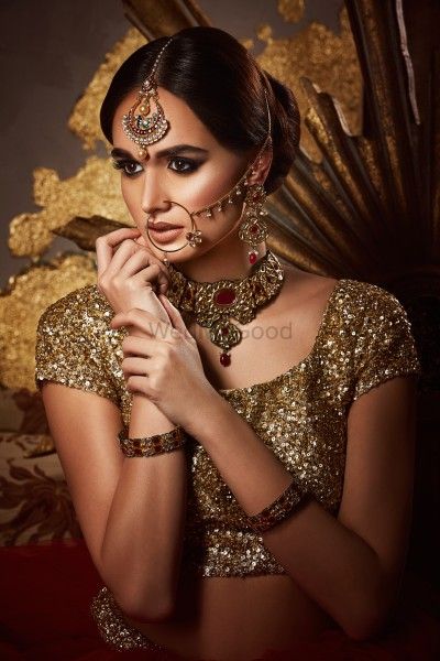Photo of Gold bridal look with maangtikka and nath