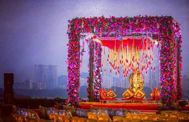 Photo of Bright pink mandap with floral arrangement