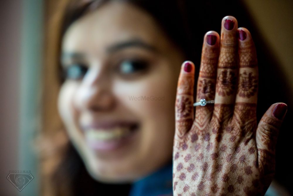 Photo of Engagement ring photography with mehendi hands
