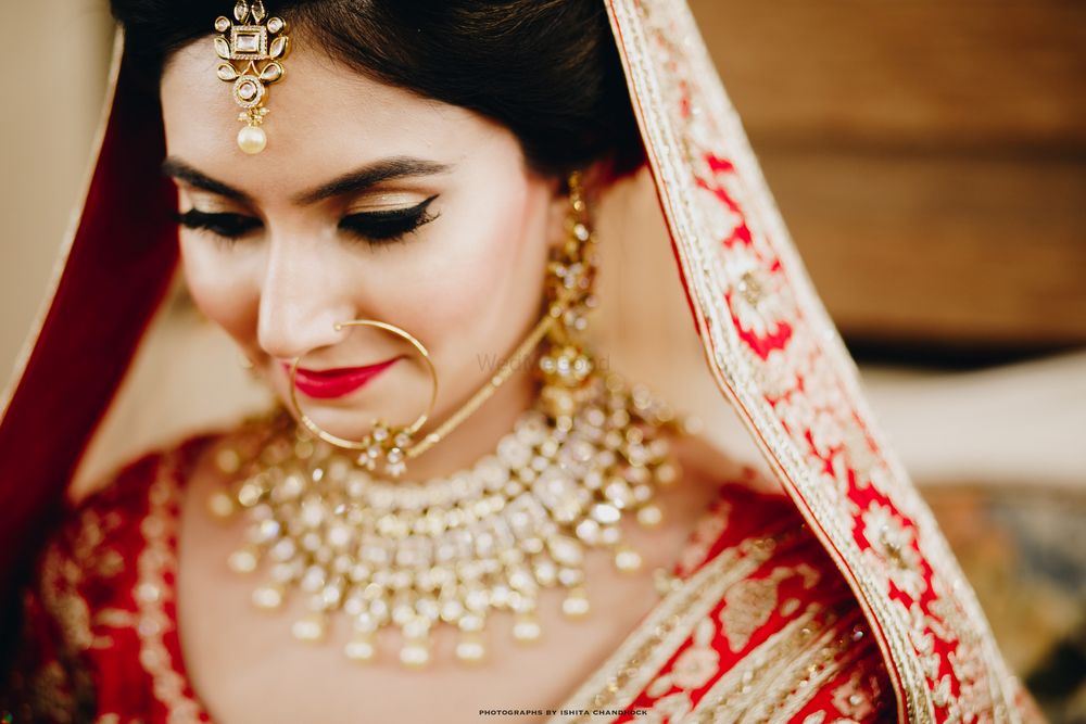 Photo of Bridal makeup with red lips and winged liner