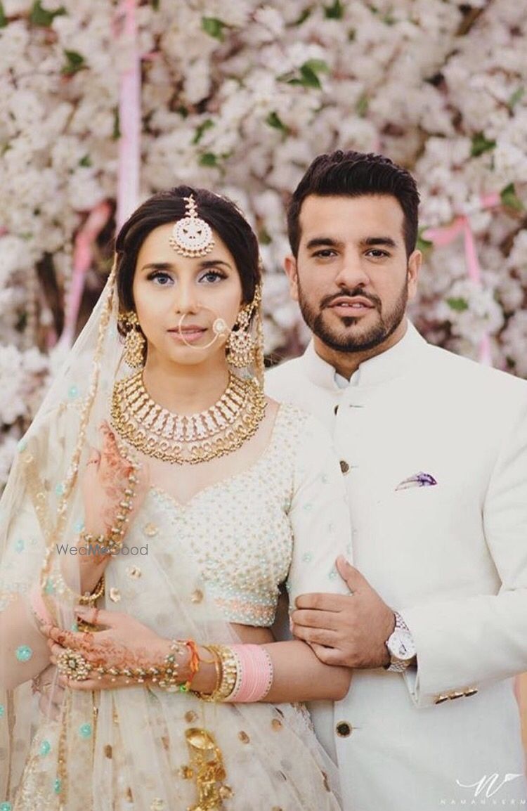 Photo of Bride and groom in white matching couple portrait