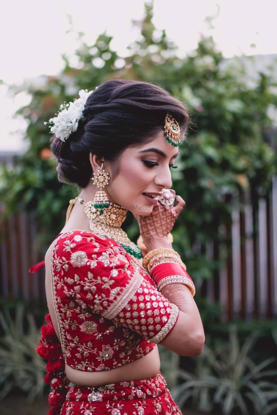 Photo of Bridal shot wearing jewellery in red lehenga