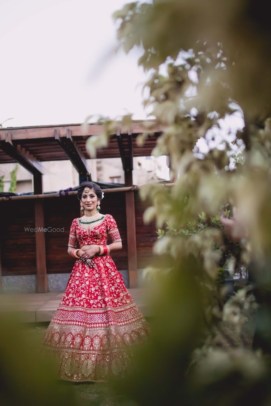 Photo of Bride in red embellished lehenga long shot