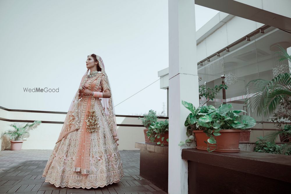 Photo of Bride dressed in a pastel pink lehenga