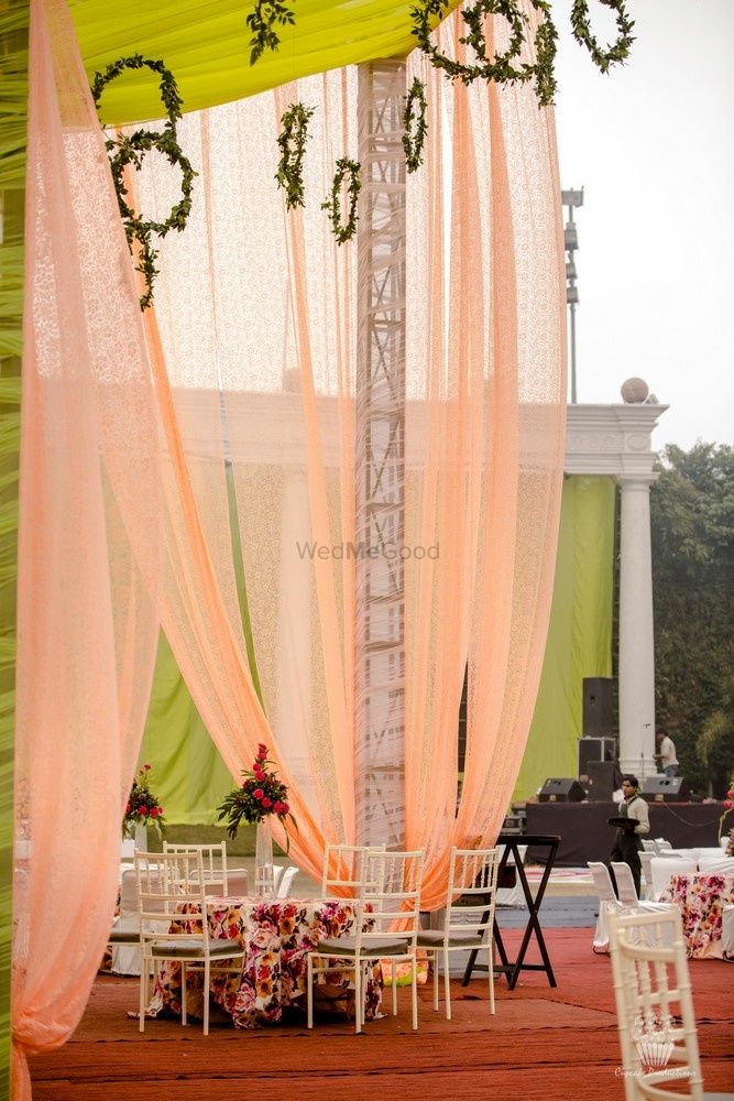 Photo of Table decor with peach curtains and hanging wreaths