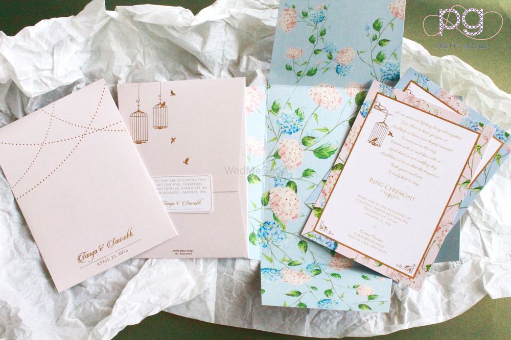 Photo of pastel blue and pink floral print wedding invite