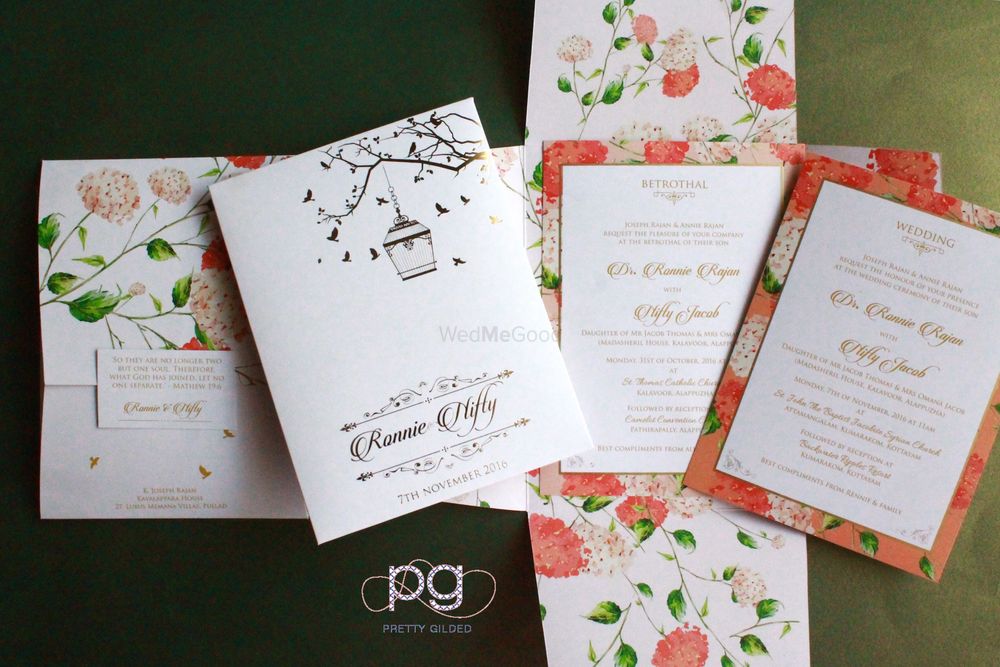 Photo of Pastel floral wedding cards with bird cage design