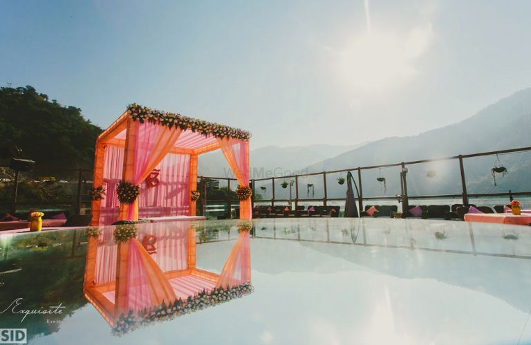 Photo of pink and orange theme pool-side mandap decor