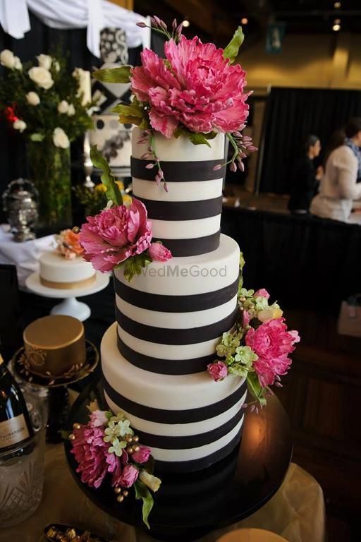 Photo of Black and white striped cake with pink flowers