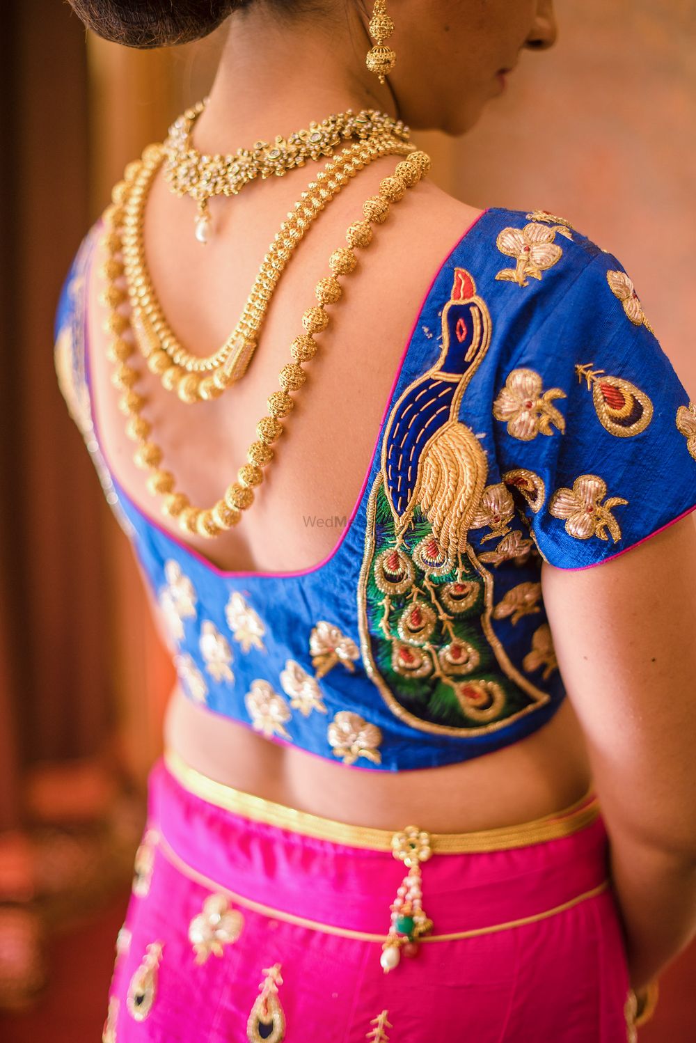 Photo of Blue blouse with peacock embroidery and back jewellery