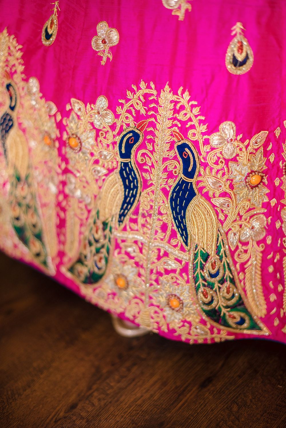 Photo of Bright pink lehenga with peacock embroidery