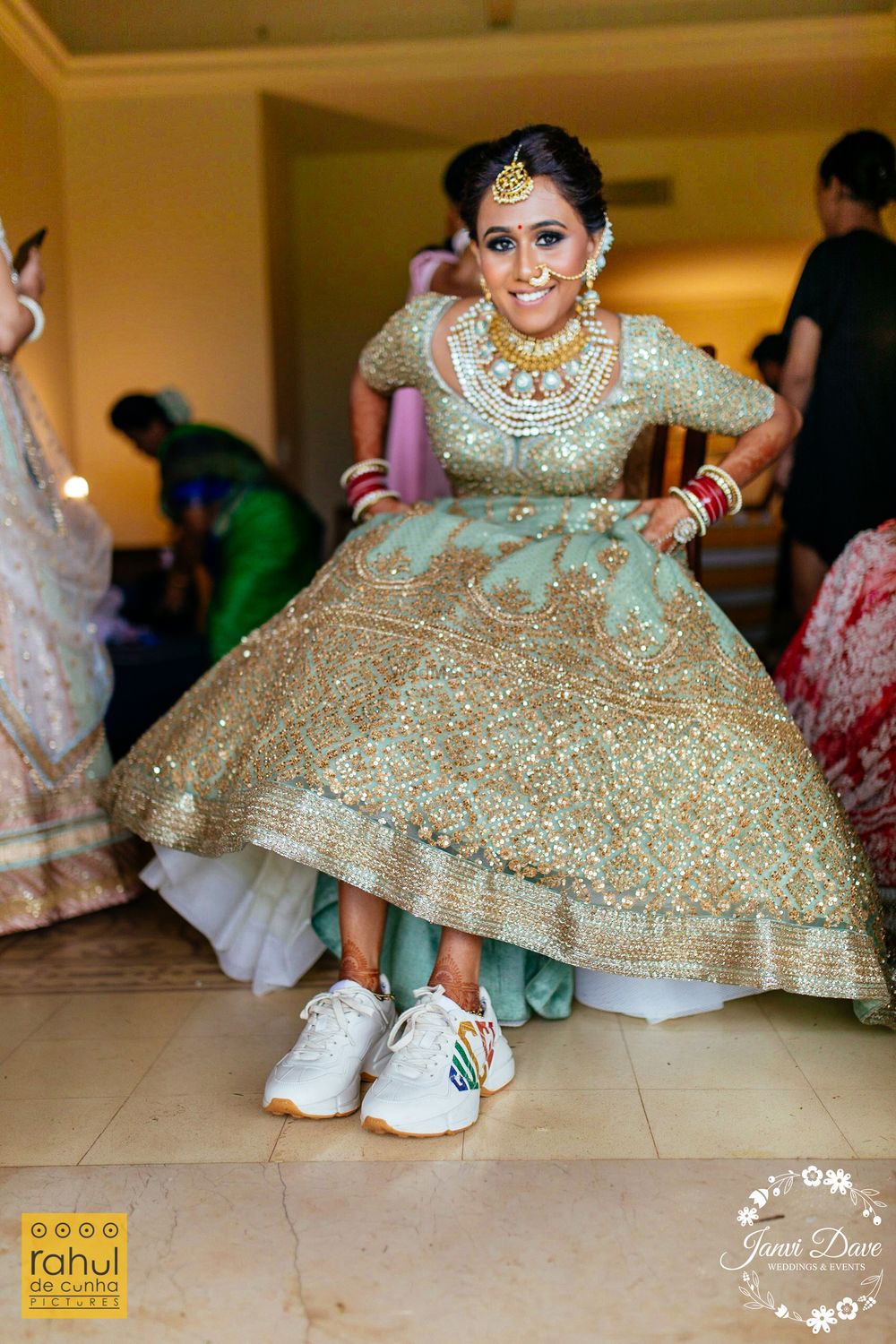 Photo of A bride in an embellished sea green lehenga with sneakers