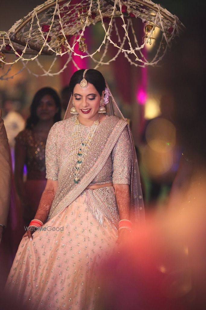 Photo of Bride in light grey and peach bridal lehenga