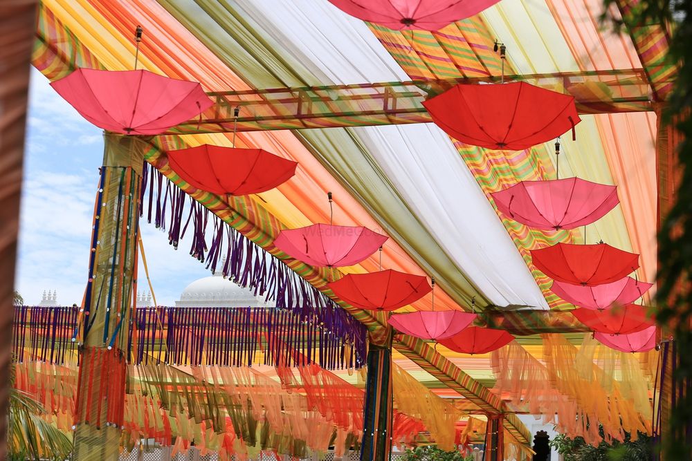 Photo of Mehendi decor idea with fringes and hanging umbrellas
