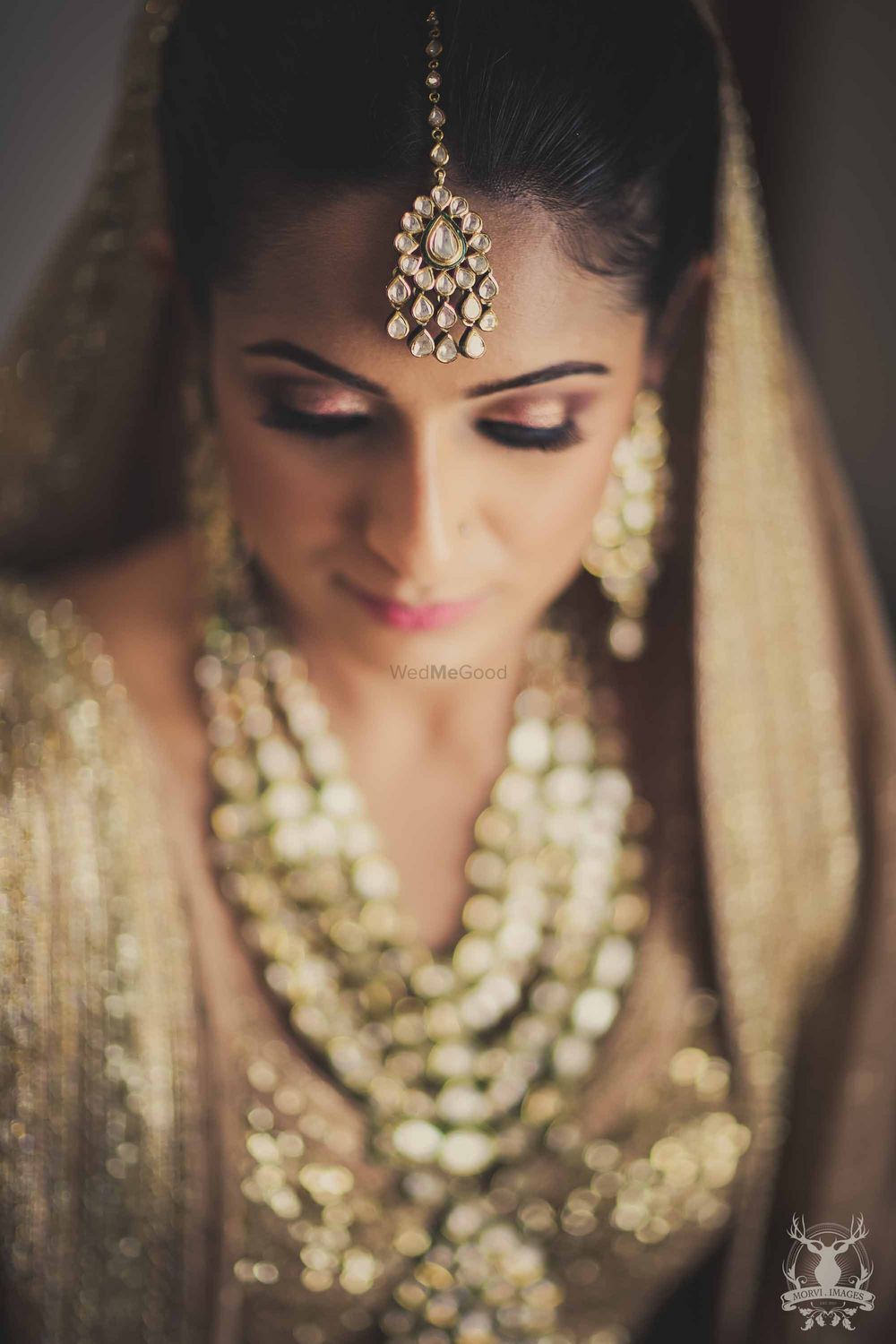 Photo of Bridal portrait with bride in gold makeup and lehenga
