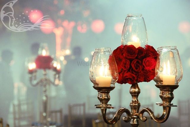 Photo of Silver Lantern Candelabras ans Roses as Table Decor