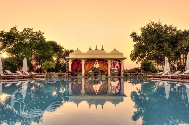 Photo of Poolside mandap decor in pink and yellow