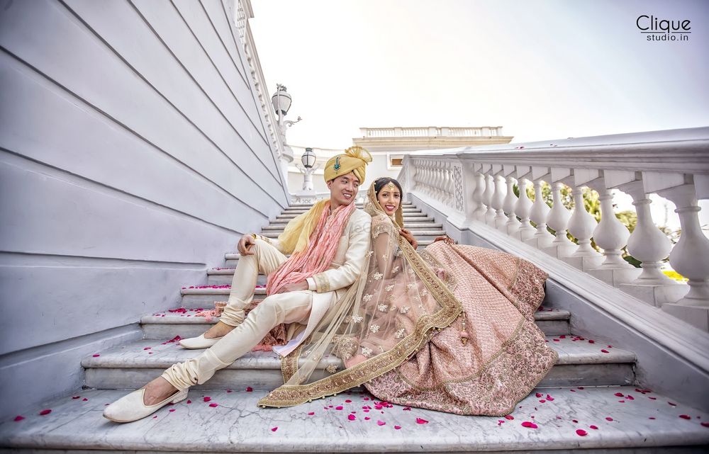 Photo of Coordinated bride and groom in light pink outfits