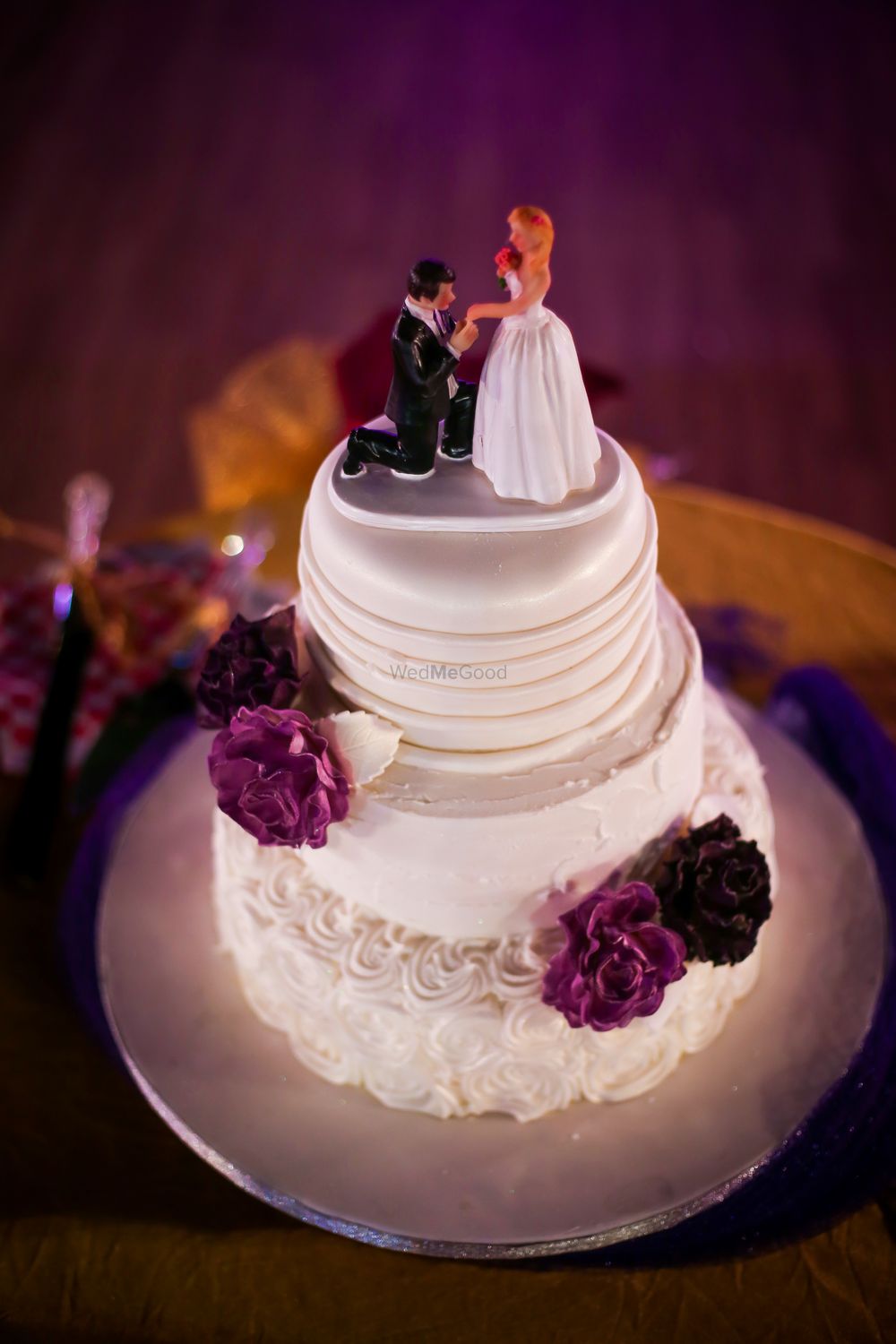 Photo of Wedding cake with proposal shot topper