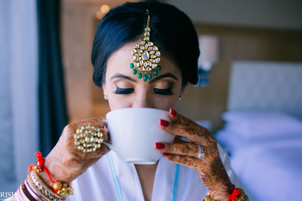 Photo of Bride drinking coffee shot before getting ready