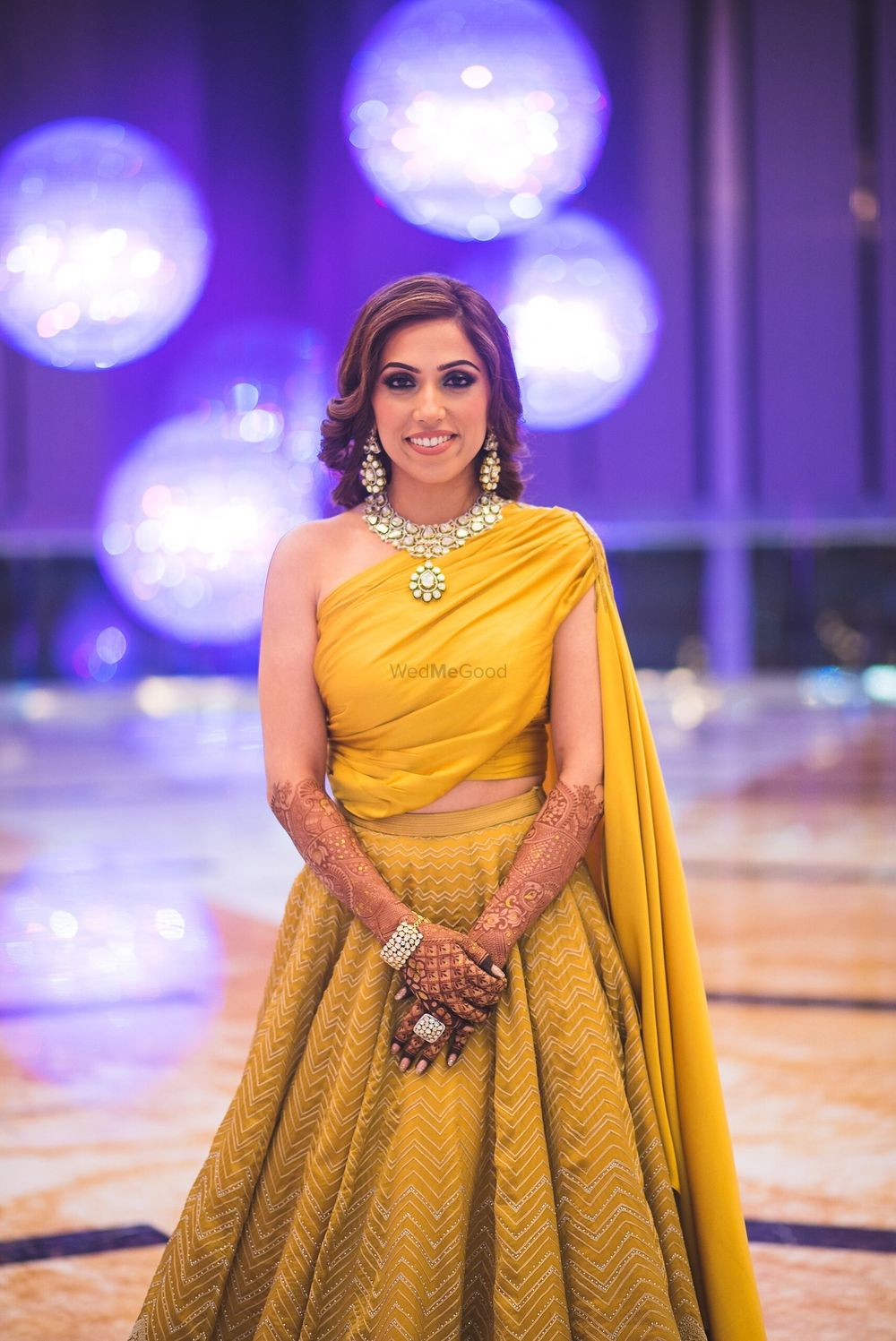 Photo of Yellow lehenga for sangeet with one shoulder blouse