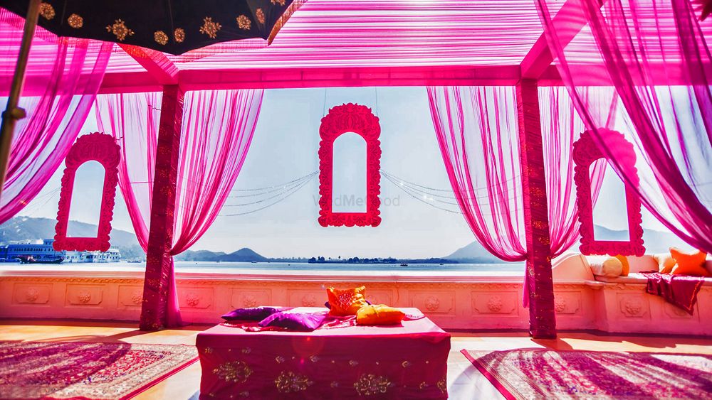 Photo of mehendi raani pink theme with frames and drapes overlooking sea