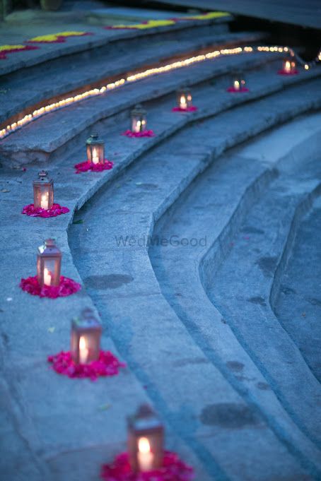 Photo of Lanterns in decor with rose petals on ground